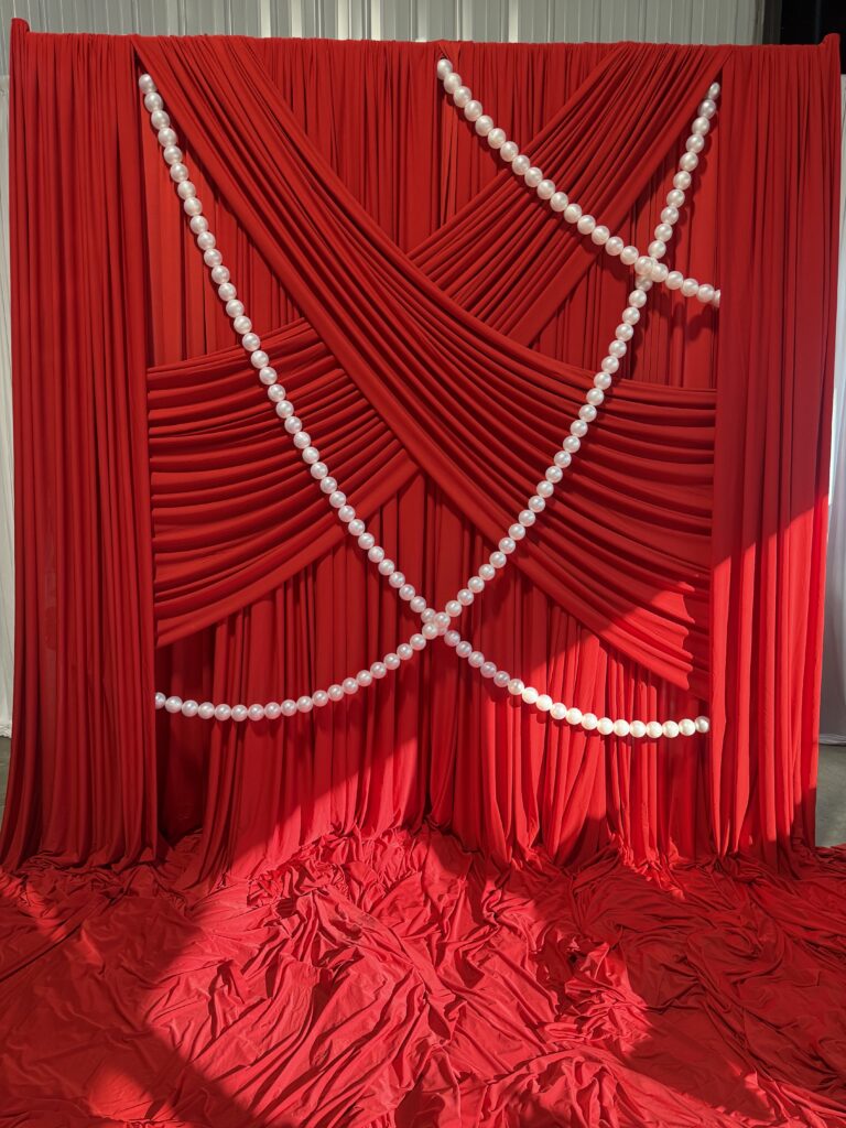 red backdrop with pearls